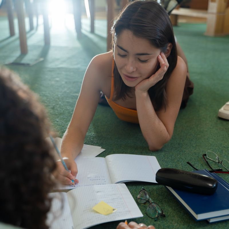 Student writing focused study notes
